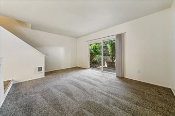 Portland apartment for rent - a living room with carpet and a sliding glass door to a patio