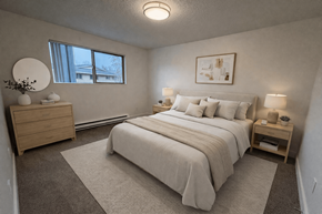 Beaverton townhouse for rent - A bedroom with a large bed, nightstands, and a window.