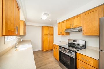 Salem apartment for rent - A kitchen with wooden cabinets and stainless steel appliances.