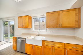 Salem apartment for rent - A kitchen with wooden cabinets and a white sink.