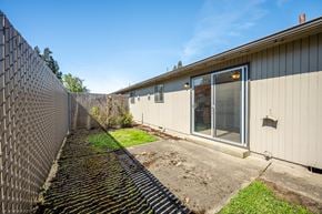 Salem apartment for rent - A metal fence runs along the side of a building.