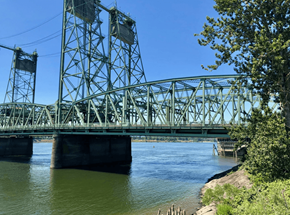 Vancouver apartment for rent - A metal bridge spans over a body of water. Clark Apartments Vancouver WA