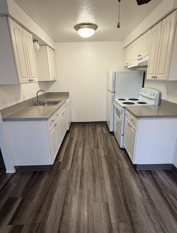 Salem apartment for rent - A kitchen with white cabinets and a white refrigerator.