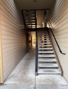 Gresham apartment for rent - A staircase with a black railing and wooden steps.