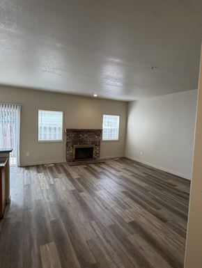 Beaverton apartment for rent - A room with a fireplace and wood flooring.
