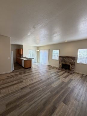 Beaverton apartment for rent - A room with a fireplace and wooden floors.