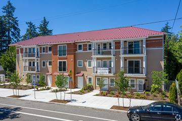 Portland apartment for rent - A building with a red roof and a sign that says "FOR LEASE".
