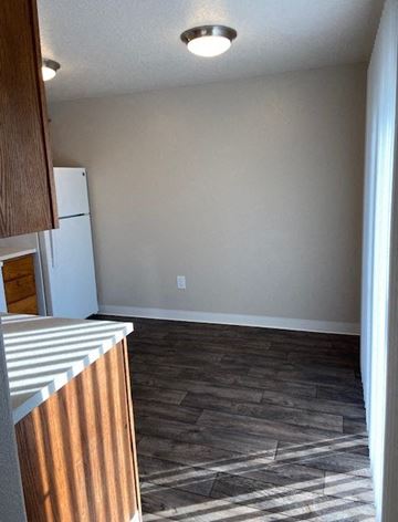 Hillsboro apartment for rent - A kitchen with a white refrigerator and wooden cabinets.