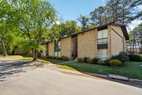 College Park apartment for rent - A brick building with a green lawn in front.