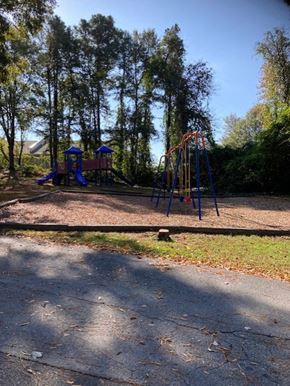 Jonesboro apartment for rent - a playground in a park with trees in the background