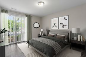 College Park apartment for rent - A bedroom with a large bed and a lamp on the side table.