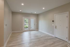 Northville apartment for rent - A spacious room with a sliding glass door leading to a patio.