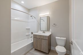 Northville apartment for rent - A bathroom with a toilet, sink, and bathtub.