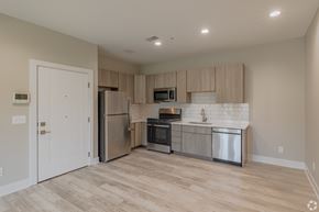 Northville apartment for rent - A kitchen with a refrigerator, oven, and microwave.