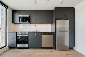 York apartment for rent - A modern kitchen with a stainless steel refrigerator and oven.