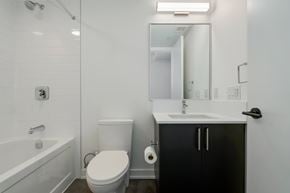 York apartment for rent - A white bathroom with a toilet, sink, and bathtub.