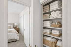 St. Louis Park apartment for rent - A white bathroom with a towel shelf and a bed.