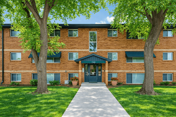 Richfield apartment for rent - A brick building with a green awning and a tree in front.