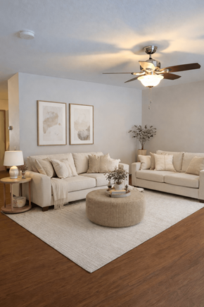 Crosby apartment for rent - A living room with a white couch, a grey rug, and a wooden floor.