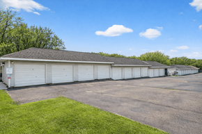 Byron townhouse for rent - A large white building with a grey roof and a parking lot in front.