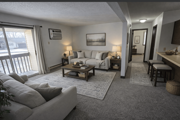New Ulm apartment for rent - A living room with a grey couch and a coffee table.