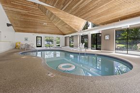 Brooklyn Park apartment for rent - A large indoor swimming pool with a wooden ceiling.