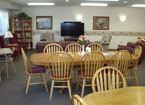 Onalaska apartment for rent - A room with a wooden table surrounded by chairs and a television on the wall.