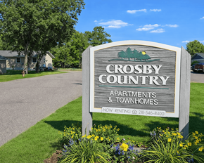 Crosby apartment for rent - A sign for Crosby Country Apartments and Townhomes with a phone number for renting.