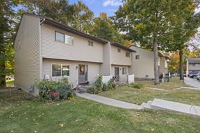 Prior Lake apartment for rent - A beige house with a grey door and windows.