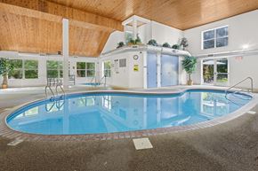Chaska apartment for rent - A large indoor swimming pool with a wooden ceiling.
