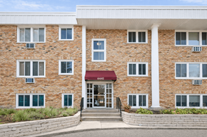 Richfield apartment for rent - A red awning is on the front door of a brick building.