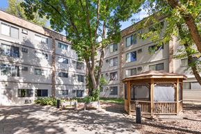 Wayzata apartment for rent - A gazebo sits in the middle of a courtyard between two apartment buildings.