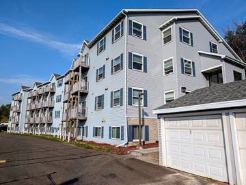Duluth apartment for rent - A large apartment building with a white garage door in front.
