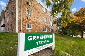 Richfield apartment for rent - A sign for Greenbrier Terrace stands in front of a brick building.