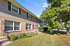 Buffalo apartment for rent - a side view of a house with a lawn and trees