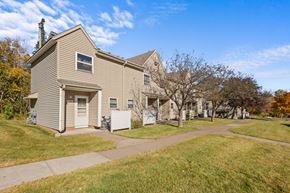 Two Harbors apartment for rent - A house with a brown roof and a white garage door.