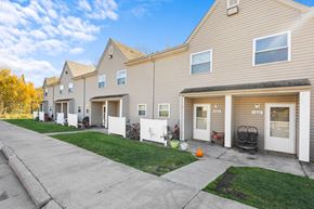 Two Harbors apartment for rent - A row of houses with garages and front yards.