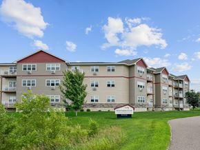 Big Lake apartment for rent - A large apartment complex named Northern Star is surrounded by green grass and trees.