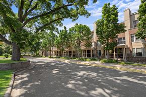 Richfield apartment for rent - A tree-lined street in front of a brick apartment building.