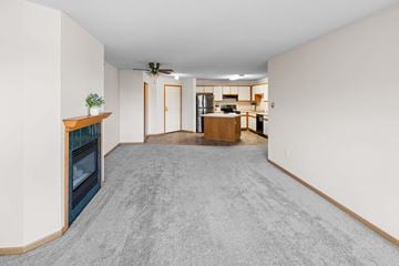 St. Cloud apartment for rent - A living room with a fireplace and a grey carpet.