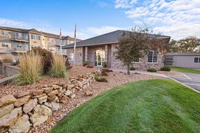 St. Cloud apartment for rent - A house with a stone wall in front of it.