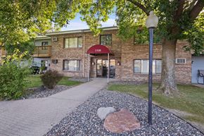 Buffalo apartment for rent - A building with the number 1508 on it is surrounded by trees and has a red awning.