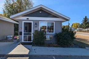 Crosby apartment for rent - a small gray house with a sidewalk in front of it