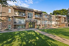 St. Louis Park apartment for rent - exterior view of the apartments with grass and trees