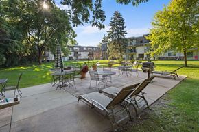 St. Louis Park apartment for rent - A sunny day at the park with tables and chairs set up for outdoor dining.