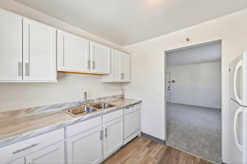 St. Louis Park apartment for rent - A kitchen with white cabinets and a marble countertop.
