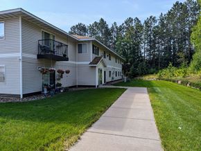 Cloquet apartment for rent - A residential area with a house and a walkway.