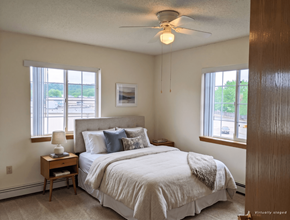 Onalaska apartment for rent - A bedroom with a large bed and a ceiling fan.