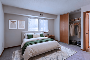 Chaska apartment for rent - A bedroom with a large bed and a wardrobe.