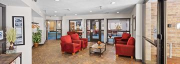 Wayzata apartment for rent - A living room with red chairs and a wooden floor.